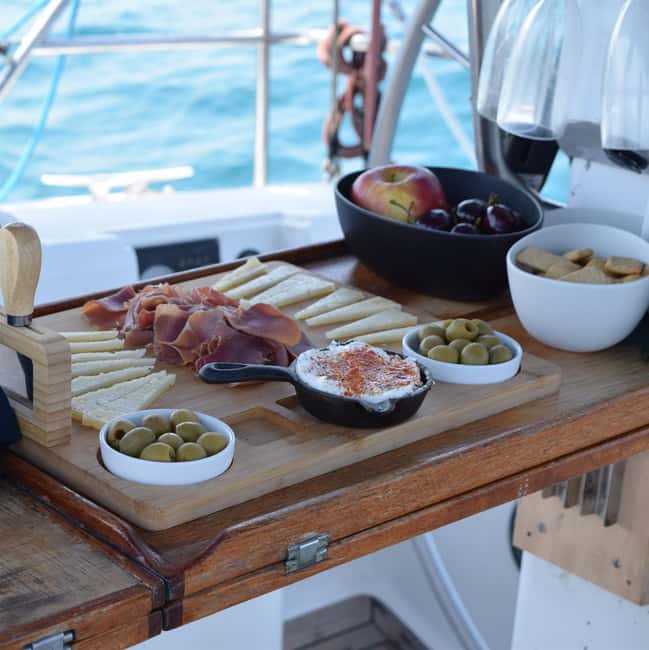 Barcelona: Sailing with Open Bar, Catalan Snack & Swim Stop - Drinks, Catalan snacks, and the music choice