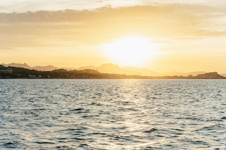 Dénia: Daytime or Sunset Catamaran Cruise - Coastal views of castle, cliffs, and caves