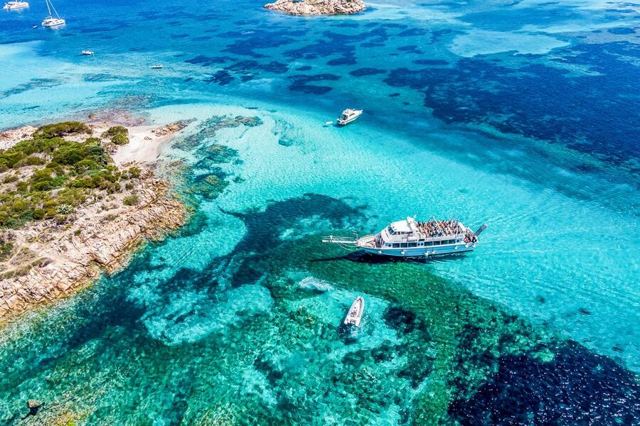 A boat anchored over clear water in the La Maddalena archipelago, Sardinia