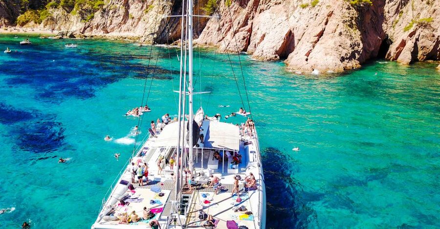 Lloret de Mar: Catamaran Sailing Cruise with BBQ and Drinks - Sailing from Lloret beach into the Costa Brava