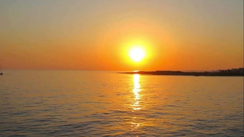 Paphos: Wave Dancer Sunset Cruise with BBQ and Swimming - Sunset views from Paphos Harbour to the coast