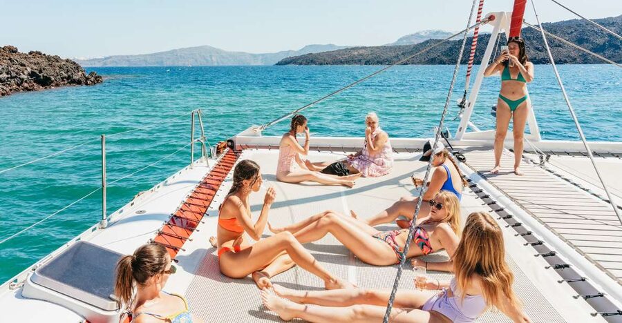 Santorini: Catamaran Tour with BBQ Dinner, Drinks, and Music - Pickup, boarding, and the port approach