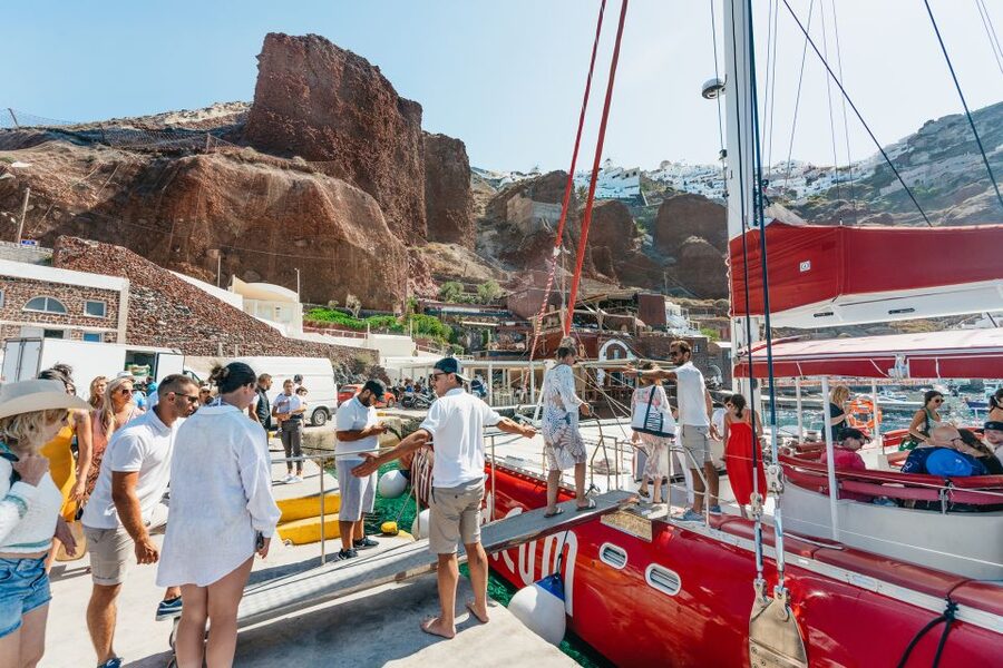Santorini: Catamaran Tour with BBQ Dinner, Drinks, and Music - White Beach and the value of a boat-only view