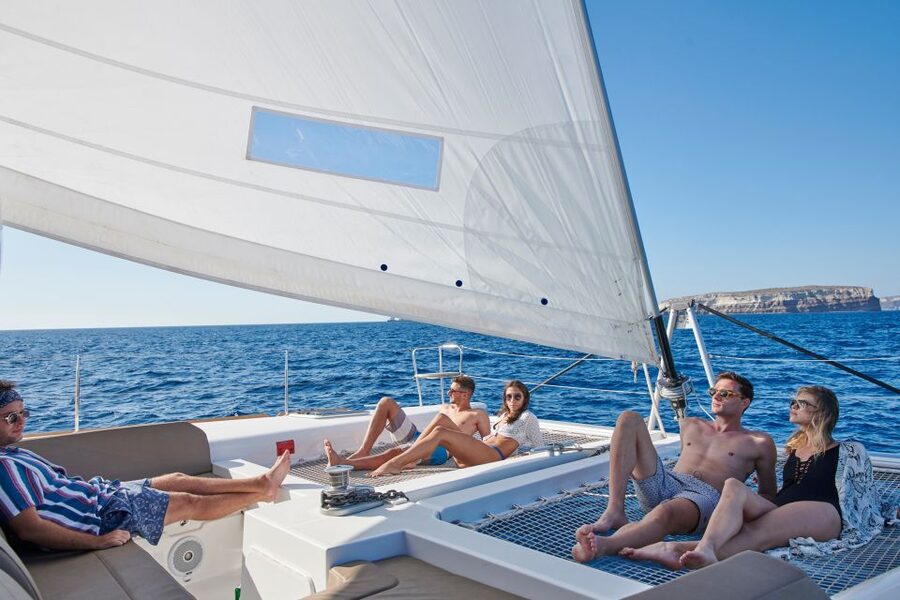 Santorini Gold Catamaran Cruise with Snorkel, BBQ & Open Bar - White Beach, the lighthouse, and coastal rock