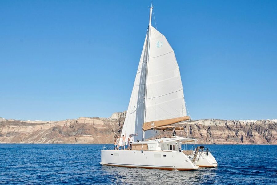 Santorini Gold Catamaran Cruise with Snorkel, BBQ & Open Bar - Mesa Pigadia and the onboard Greek BBQ