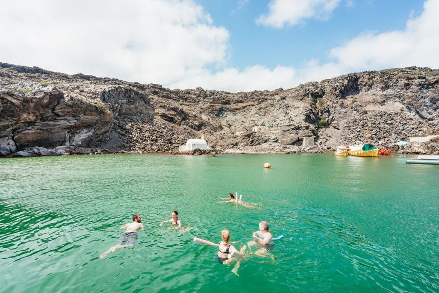 Santorini: Luxury Catamaran Day Trip with Meal and Open Bar - Music, space, and the sunset below Oia