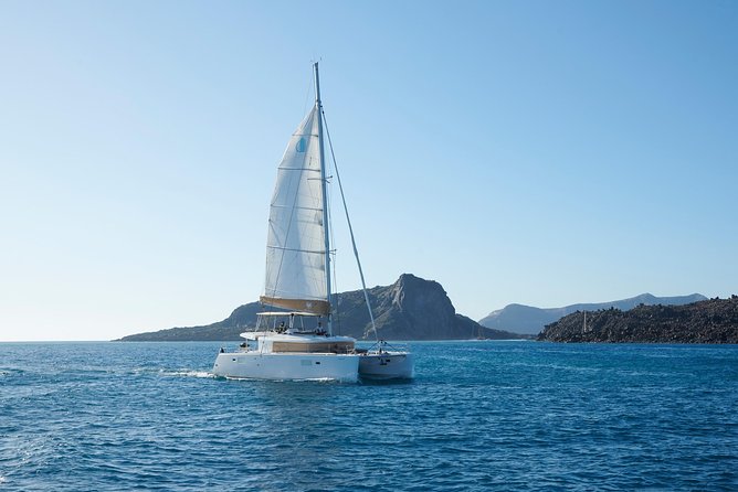 Santorini Platinum Catamaran Cruise with Meal, BBQ and Open Bar - The Akrotiri lighthouse adds a quieter sightseeing moment