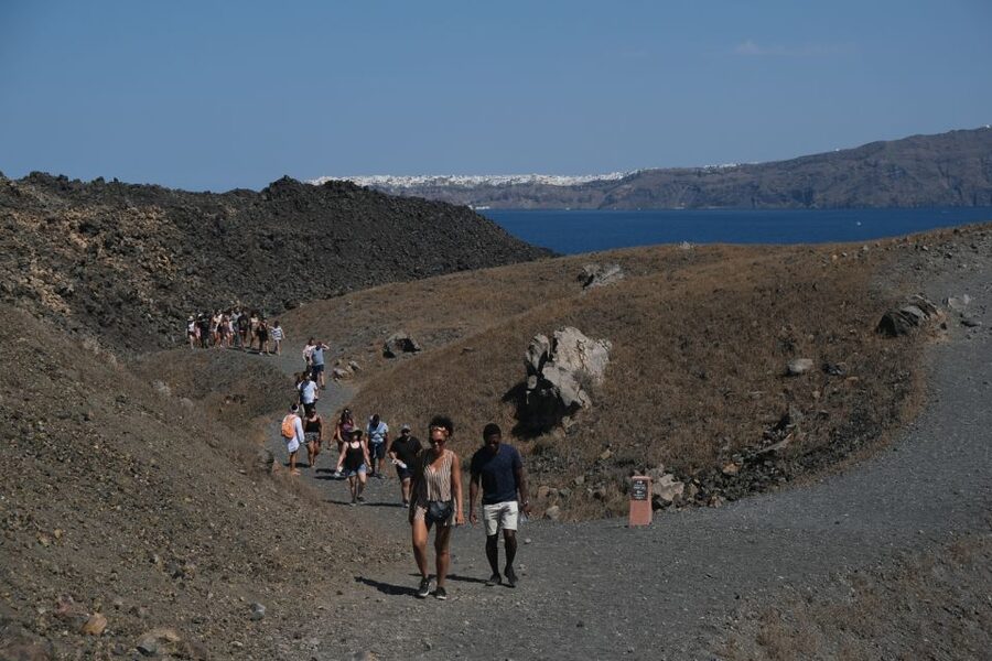 Santorini: Volcano and Hot Springs Sunset Dinner Cruise - Walking Across Nea Kameni’s Volcanic Ground
