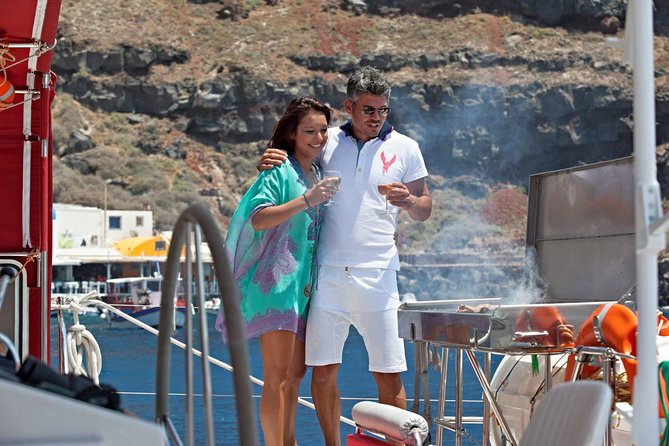 Sunset Sailing Catamaran Cruise in Santorini with BBQ and Drinks - Red Beach by boat, with time to swim